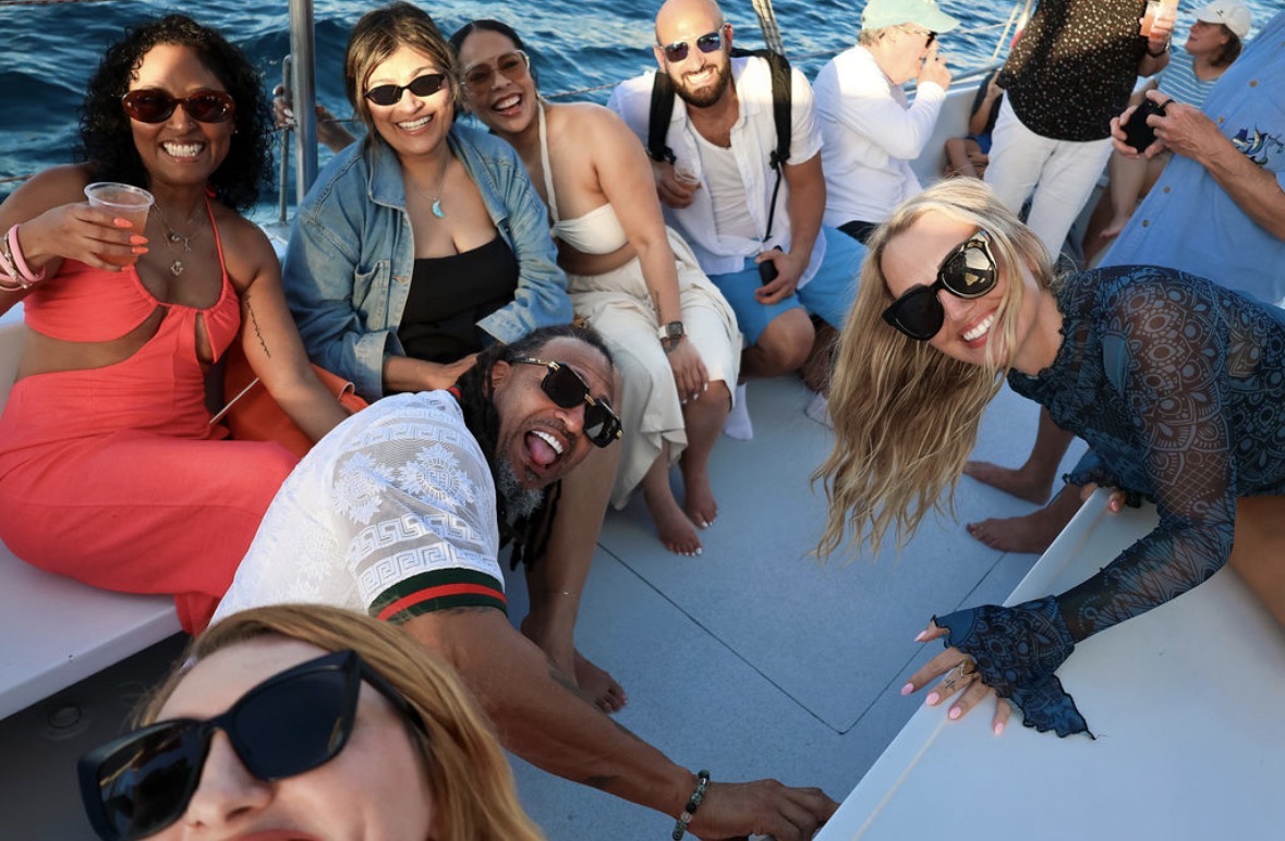 Retreat guests laughing together on a sailboat